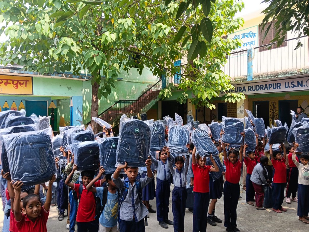 Students holding up their new school bags at Rampura school